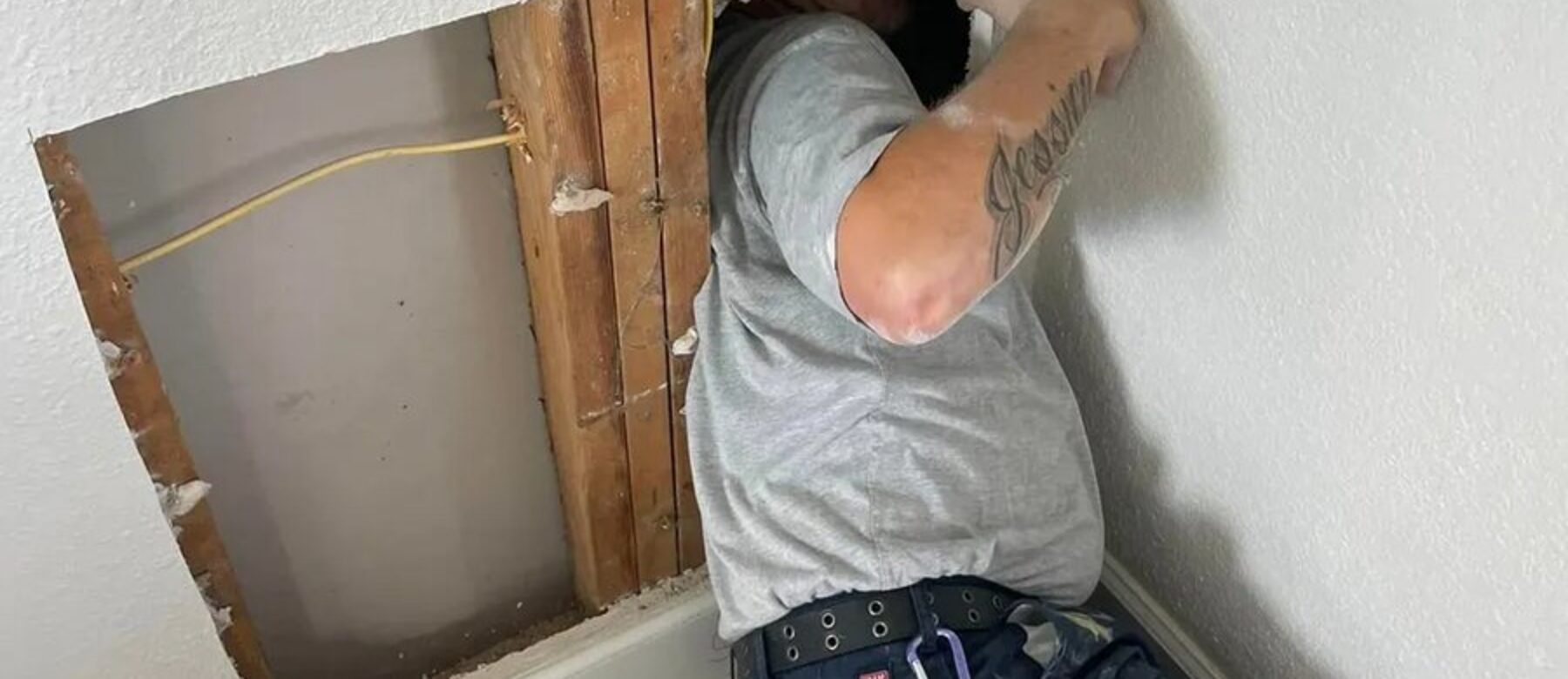 A wall opened up to replace a failed section of pipe